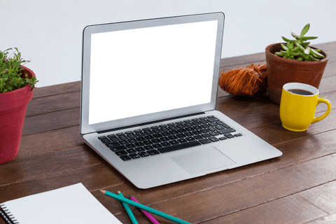 transparent laptop on office table with plants and coffee mug - Download Free Stock Videos Pikwizard.com