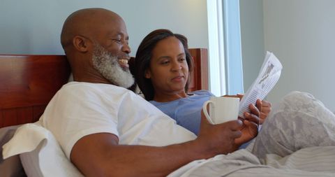 Senior Couple Relaxing in Bed with Newspaper and Coffee - Download Free Stock Images Pikwizard.com