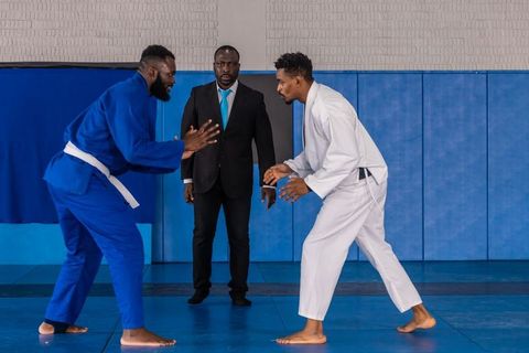Judo referee supervising martial arts competitors in match