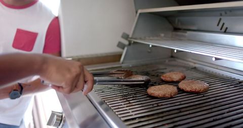 Person Flipping Burgers on Stainless Steel Grill Outdoors - Download Free Stock Images Pikwizard.com