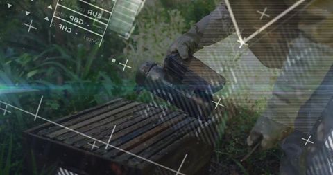 Beekeeper tending hives using smoker in green environment
