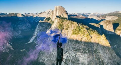 Person Holding Purple Smoke against Yosemite Mountains