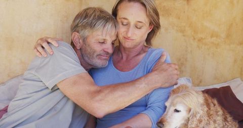 Senior Couple Embracing with Dog, Sharing Tranquil Moments Outdoors