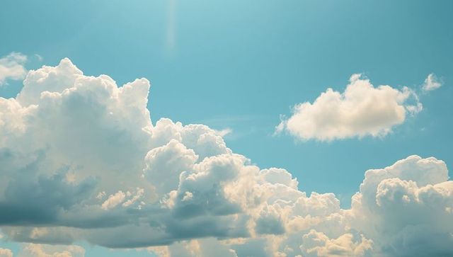 Serene cumulus clouds floating in tranquil blue sky