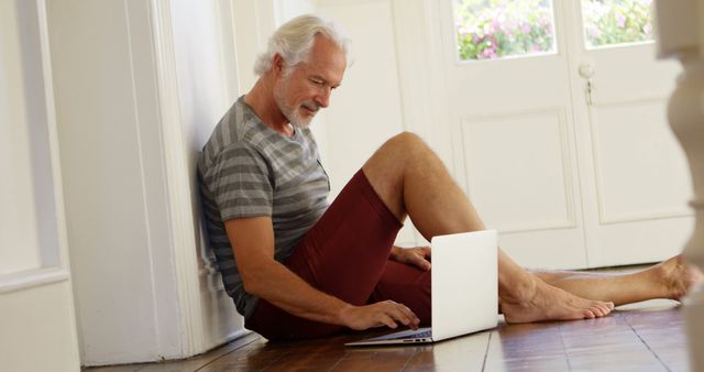 Senior Man Relaxing at Home Using Laptop in Casual Wear - Download Free Stock Images Pikwizard.com