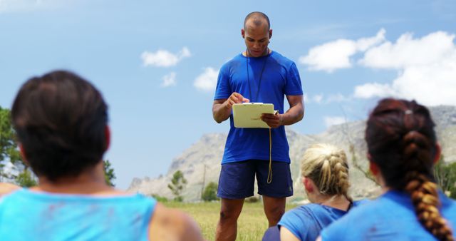 Fitness Coach Leading Outdoor Training Session with Clipboard - Download Free Stock Images Pikwizard.com