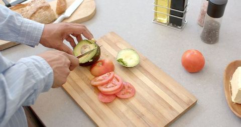 Preparing Fresh Avocado and Tomato in Modern Kitchen