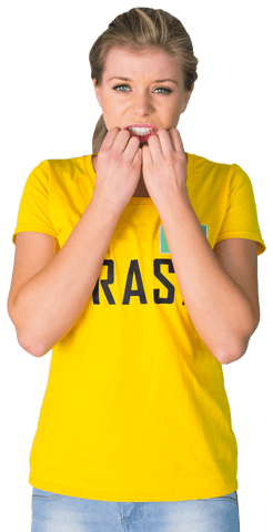 Nervous football fan in transparent brazil t-shirt with tense expression