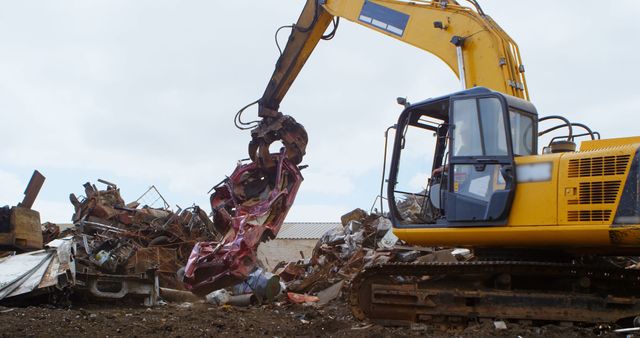 Bulldozer in scrap yard with waste and copy space. Global waste management, wasteland and rubbish.