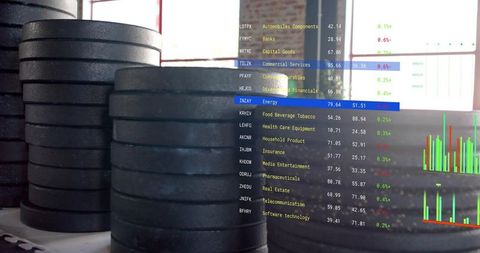 Stacked gym weight plates with financial market data overlay conveying fitness investment concept