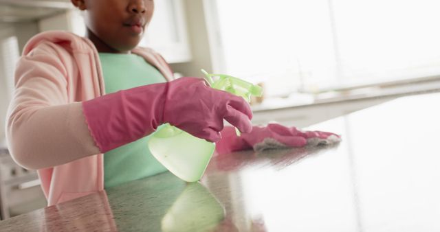 Child Cleaning Kitchen Counter with Spray Bottle - Download Free Stock Images Pikwizard.com