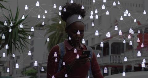 Urban Woman Engaged with Digital Connectivity in Cityscape