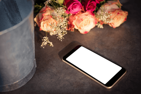 transparent mobile phone on dark table with roses and bouquet - Download Free Stock Videos Pikwizard.com