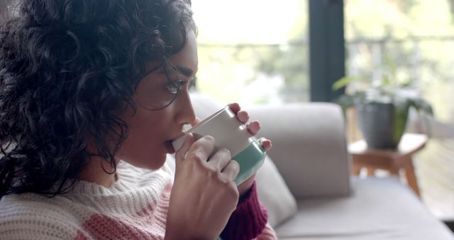 Young Woman Relaxing with Coffee on Sofa - Download Free Stock Images Pikwizard.com