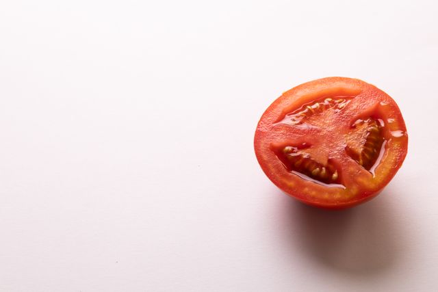 Directly above view of fresh tomato halves by copy space on white background. unaltered, food, healthy eating, organic concept.