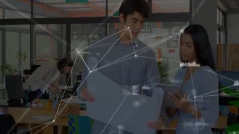 Colleagues Analyzing Blueprint and Data in Modern Office