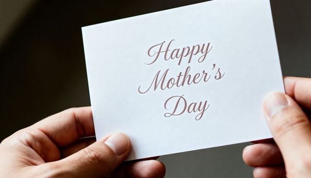 Holding Mother's Day Greeting Card Closeup with Elegant Maroon Cursive Text and Hands
