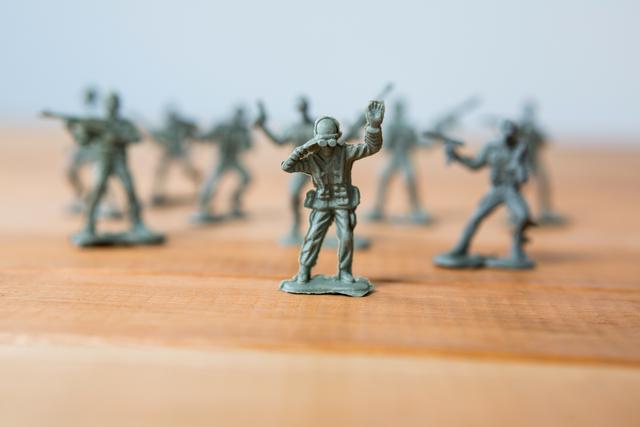 Miniature figurine of army soldier with binocular in battle