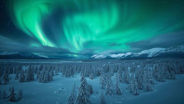 Majestic Northern Lights Over Snow-Covered Arctic Landscape