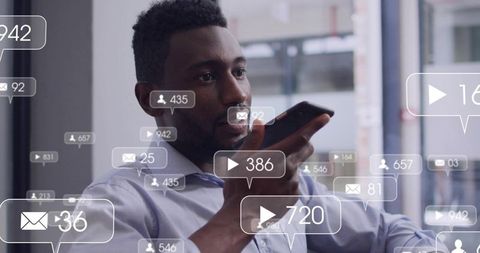 Executive speaking into smartphone while receiving social media and message notifications
