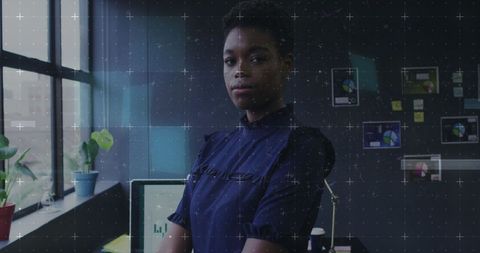 Confident Businesswoman in Modern Office with Digital Interface Overlay