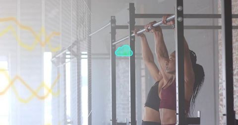 Women Performing Pull-Ups in Sunlit Gym, Training Partners Building Upper-Body Strength
