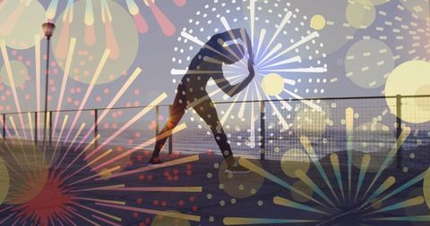 Silhouette of man stretching with vibrant fireworks overlay