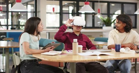 African American Student Using VR with Peers in Modern Coworking Study Hub