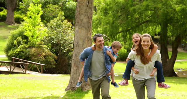 Happy Family Enjoying Outdoor Playtime in Sunny Park - Download Free Stock Images Pikwizard.com