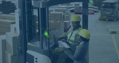 Forklift Operator and Colleague Reviewing Inventory with Laptop in Depot