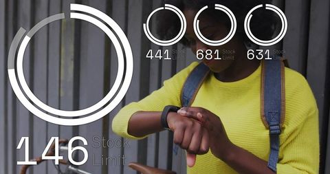 Commuter adjusting smartwatch at bike rack displaying hud fitness graphics urban cycling