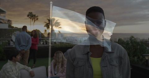Diverse friends enjoying rooftop terrace sunset gathering