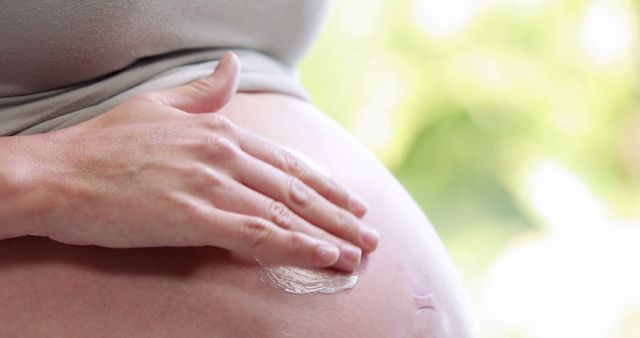 Pregnant Woman Applying Cream on Belly for Stretch Marks Prevention - Download Free Stock Images Pikwizard.com