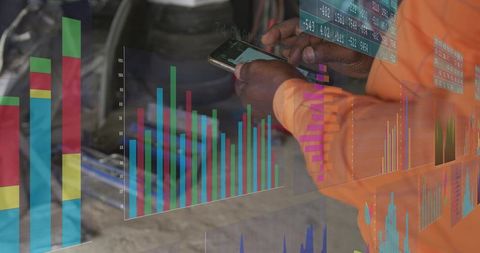 Technician checking smartphone with augmented reality analytics overlay in workshop