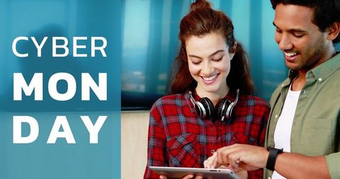 Cheerful couple online shopping on tablet during cyber monday