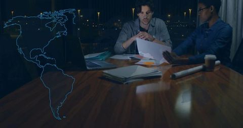 Business Professionals Innovating with Hologram Technology at Night