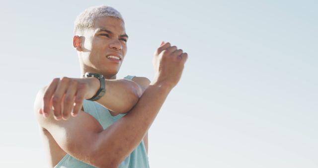 Determined Athlete Stretching under Clear Sky - Download Free Stock Images Pikwizard.com