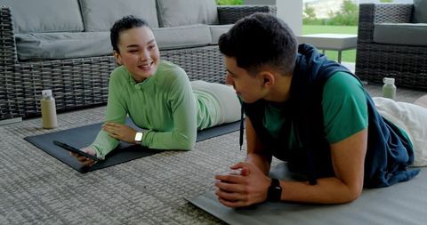 Relaxed fitness chat between friends on patio