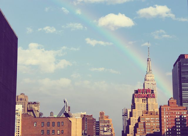 Rainbow arching over New York City skyline with a retro aesthetic. Ideal for use in travel blogs, urban landscape projects, or as wall art capturing iconic New York moments.