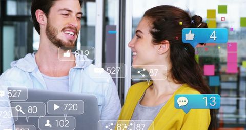 Smiling professionals with social media icons in office setting