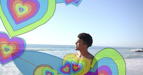 Man at beach with surfboard surrdo-rounded by colorful hearts graf-right nameni tunda