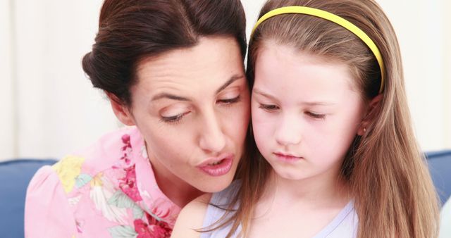 Mother comforting sad daughter on couch at home - Download Free Stock Images Pikwizard.com