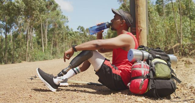 Man with Prosthetic Leg Taking Break from Hiking and Drinking Water - Download Free Stock Images Pikwizard.com