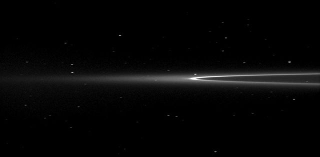 NASA Cassini spacecraft looks toward Saturn tiny moon Aegaeon within the G-ring arc. The moonlet Aegaeon formerly known as S/2008 S 1 cant be seen in this image, but it orbits in the bright arc of Saturn faint G ring shown here.