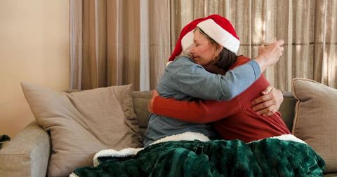 Senior Couple Enjoying Cozy Holiday Embrace with Santa Hats