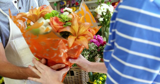 Florist giving bouquet of flower to customer in flower shop
