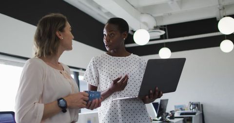 Female Colleagues Collaborating in Modern Office Setting