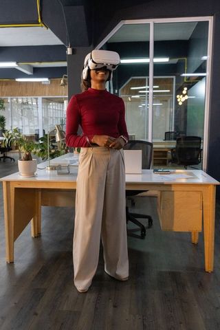 Indian woman using vr headset in modern office for virtual collaboration and training
