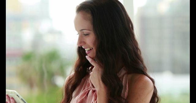 Smiling Woman with Long Hair Looking at Phone - Download Free Stock Images Pikwizard.com