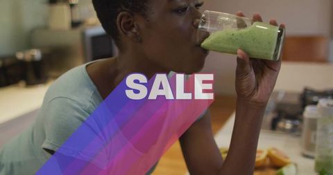 Woman sipping green smoothie in minimalist kitchen with sale text